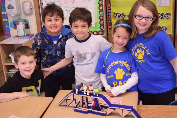 Children building a bridge with building blocks.