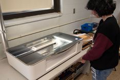 A student watching the laser cutter.