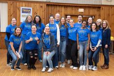 Members of the CFEE Board posing for a photo in matching blue and yellow CFEE t-shirts.